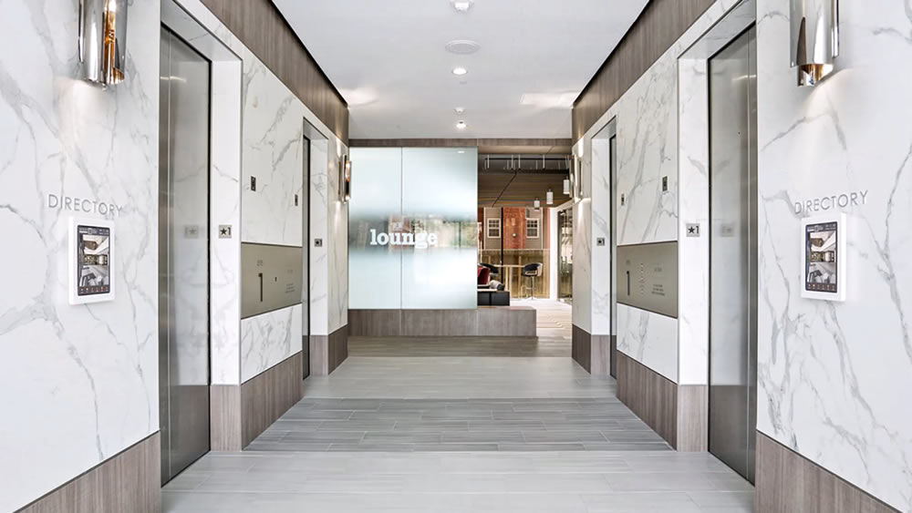 Ortho view of Premium office elevator hallway, with two InforCenter stations mounted on each side wall