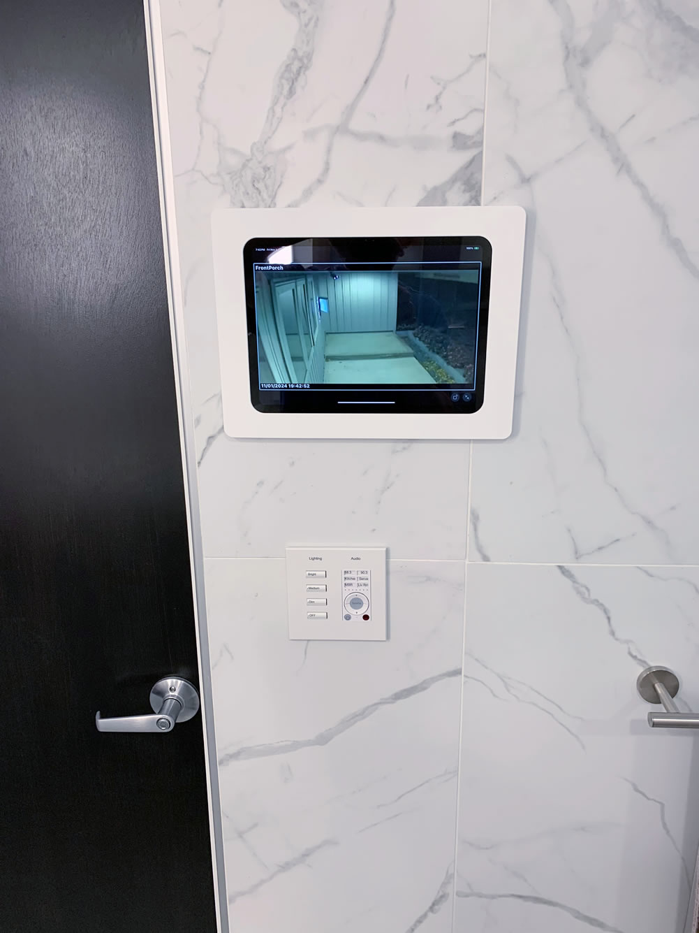 A wall mounted iPad showing a camera app displaying the video feed for the front porch